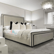 cream bedframe with black border and mattress