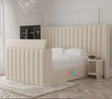 Beige upholstered tv bed with oversized headboard and storage made by heavenlybeds